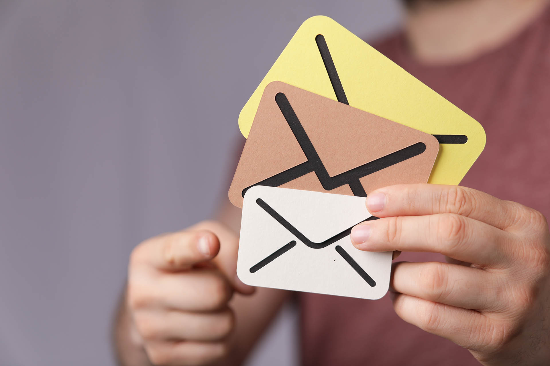 Sign of the messages made of paper in the hands of a man